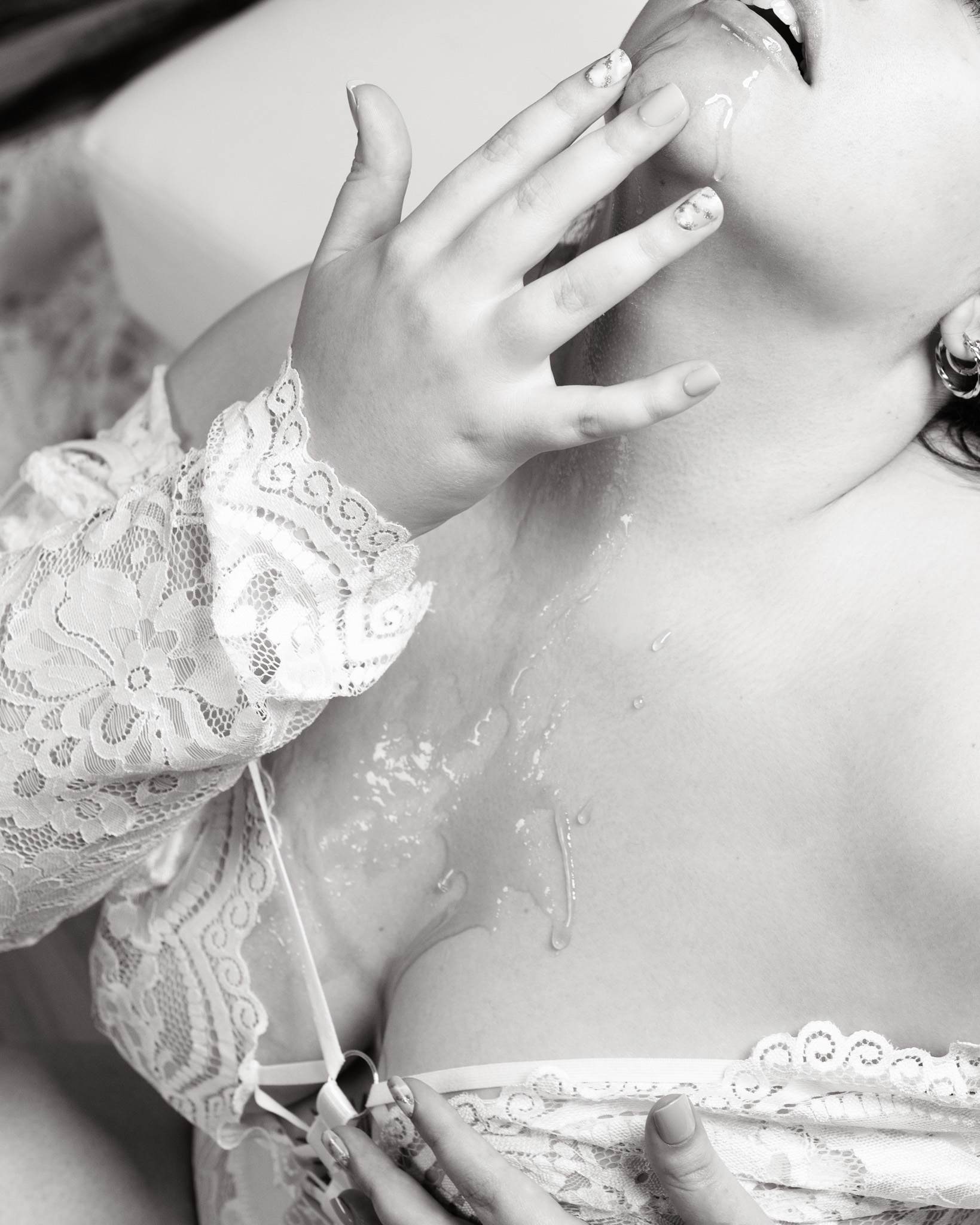 Closeup of a woman with her head tilted back and her fingers gently touching her chin