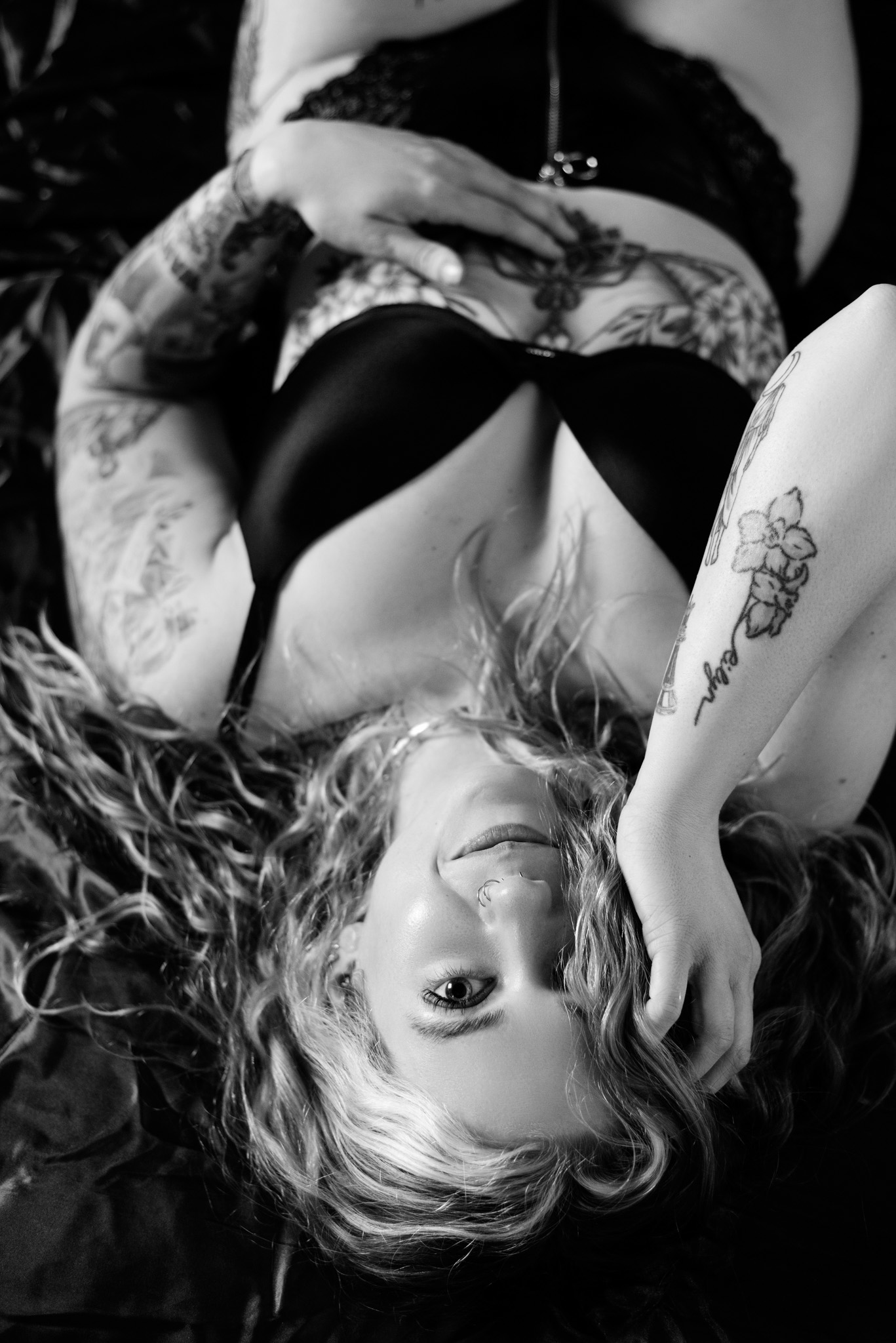 Boudoir photo of a woman looking at the camera with a coy look on her face