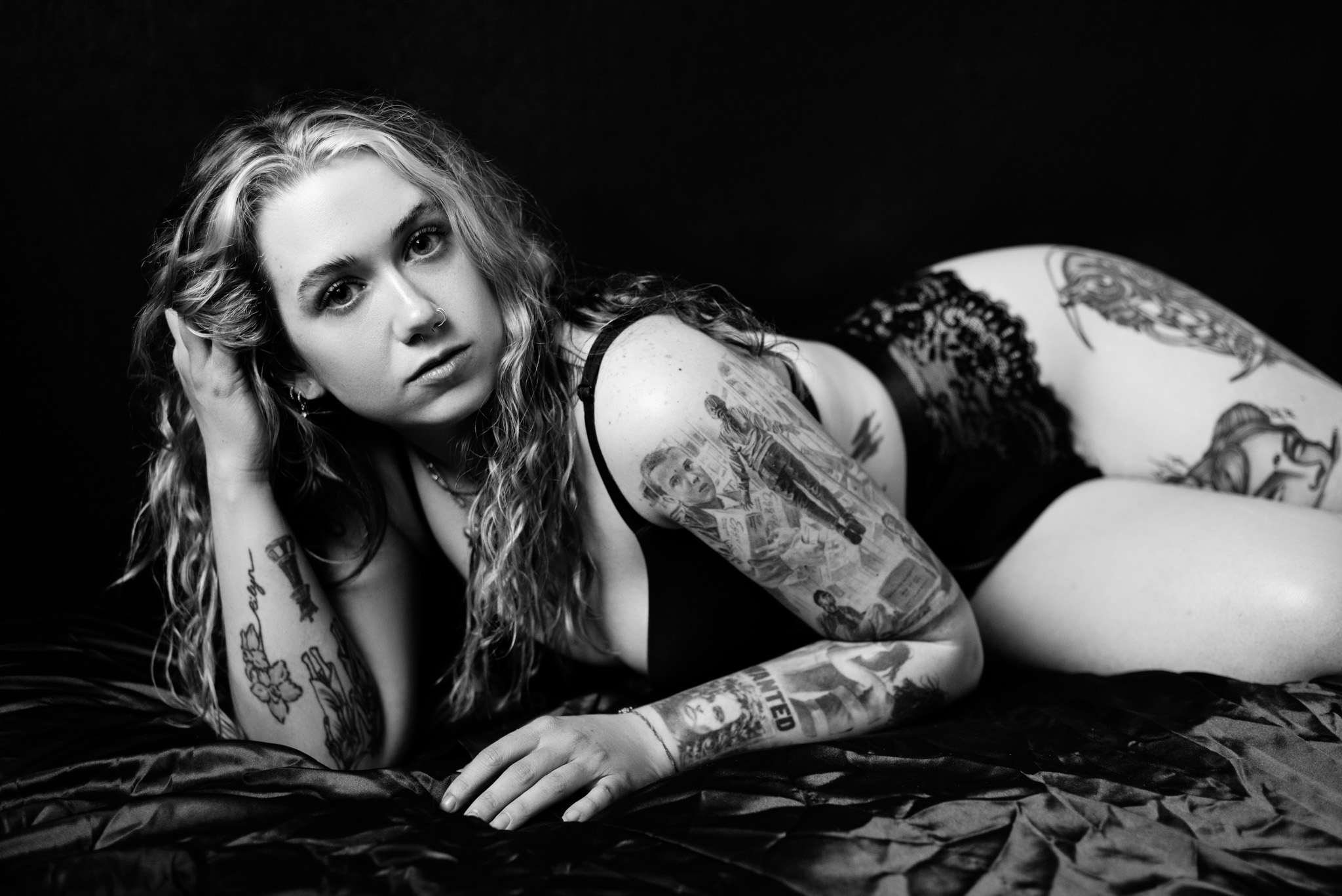 Black and white image of a woman lying on her side